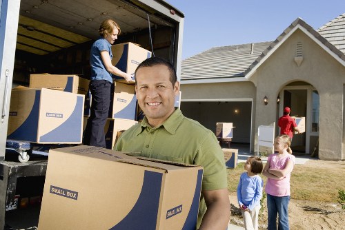 Commercial office moving service preparing furniture and files for transport in Kingston